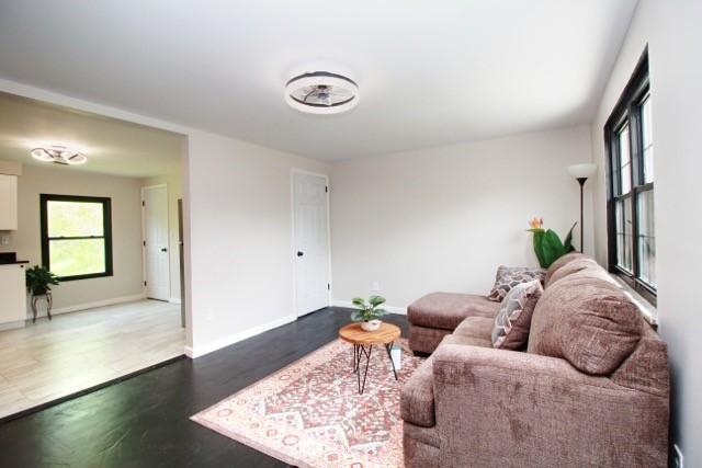 513 Crestview Dr, Plum Boro, PA 15239 - living area featuring healthy amount of natural light, wood finished floors, and baseboards