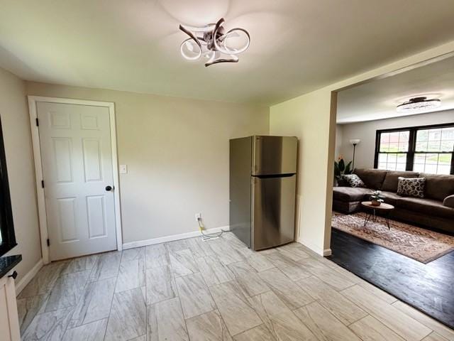513 Crestview Dr, Plum Boro, PA 15239 - living area featuring a chandelier, light wood-style flooring, and baseboards