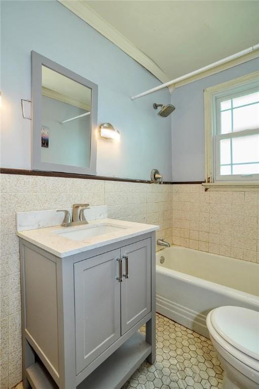 full bathroom featuring tile walls, vanity, tile patterned flooring, a wainscoted wall, and toilet