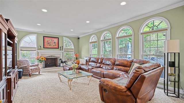 living area with carpet floors, plenty of natural light, crown molding, a fireplace, and recessed lighting