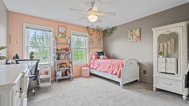 bedroom featuring light carpet, ceiling fan, and baseboards