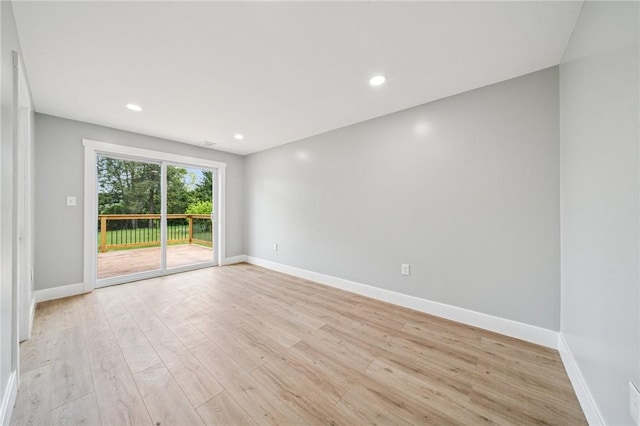 empty room featuring light wood-style flooring, baseboards, and recessed lighting