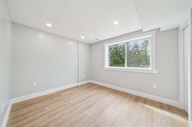 empty room with baseboards, light wood-style floors, and recessed lighting