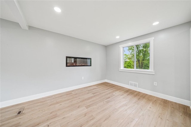 unfurnished room featuring light wood-style floors, baseboards, beam ceiling, and recessed lighting
