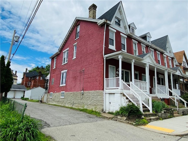 811 Farragut St, Highland Park, PA 15206 - view of front facade with a porch, brick siding, and a chimney