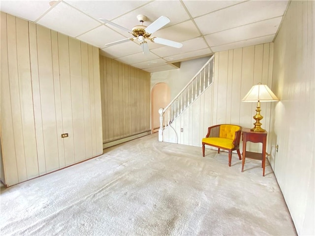 811 Farragut St, Highland Park, PA 15206 - living area featuring arched walkways, carpet flooring, a drop ceiling, wooden walls, and baseboard heating