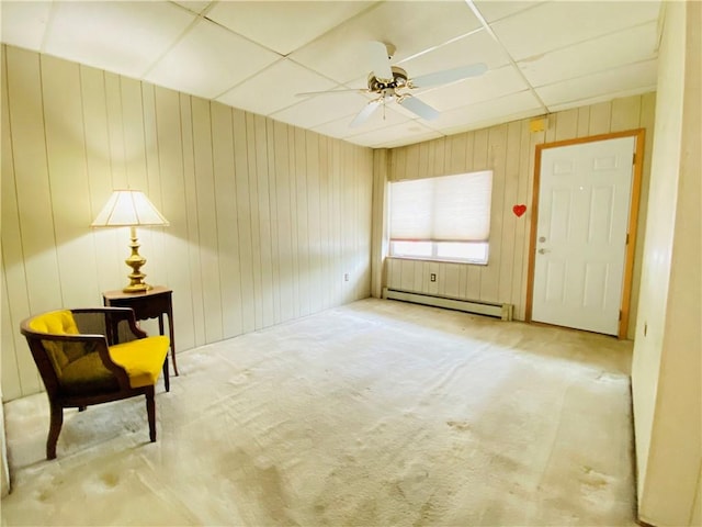 811 Farragut St, Highland Park, PA 15206 - unfurnished room featuring a baseboard radiator, carpet, a ceiling fan, a paneled ceiling, and wood walls