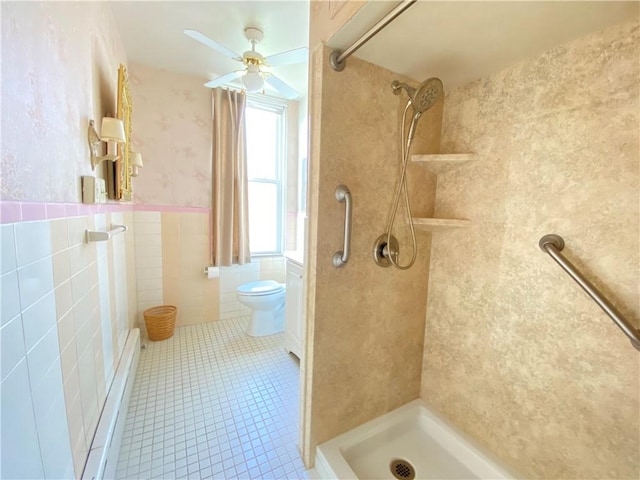 811 Farragut St, Highland Park, PA 15206 - bathroom with tile walls, a tile shower, tile patterned floors, ceiling fan, and wainscoting