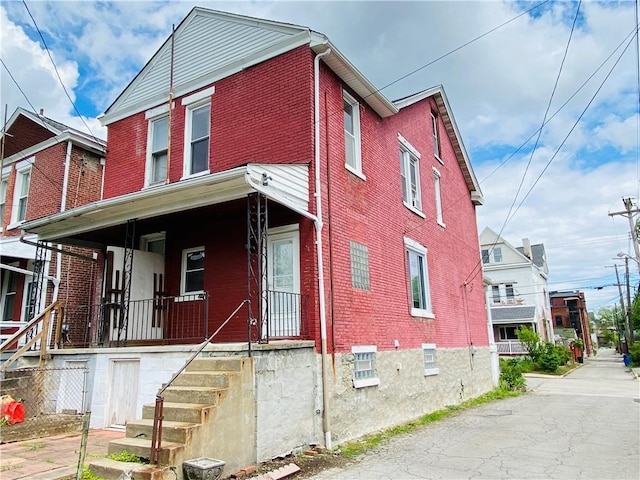811 Farragut St, Highland Park, PA 15206 - view of front of house featuring brick siding and covered porch
