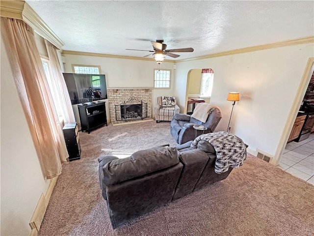 5422 Library Rd, Bethel Park, PA 15102 - tiled living area with carpet floors, a ceiling fan, a textured ceiling, ornamental molding, and a brick fireplace