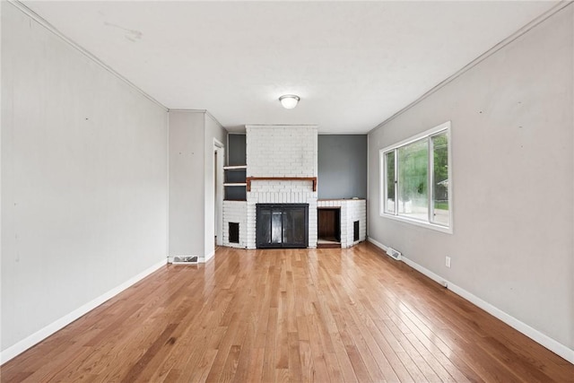 28 Main St, Clarksville, PA 15322 - unfurnished living room featuring light wood-style floors, a fireplace, baseboards, and crown molding