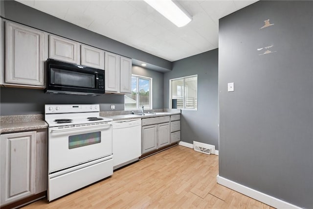 28 Main St, Clarksville, PA 15322 - kitchen featuring white appliances, light wood-type flooring, light countertops, baseboards, and a sink