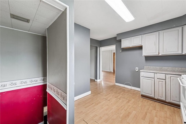 28 Main St, Clarksville, PA 15322 - kitchen with light wood-style flooring, light countertops, baseboards, and white cabinets