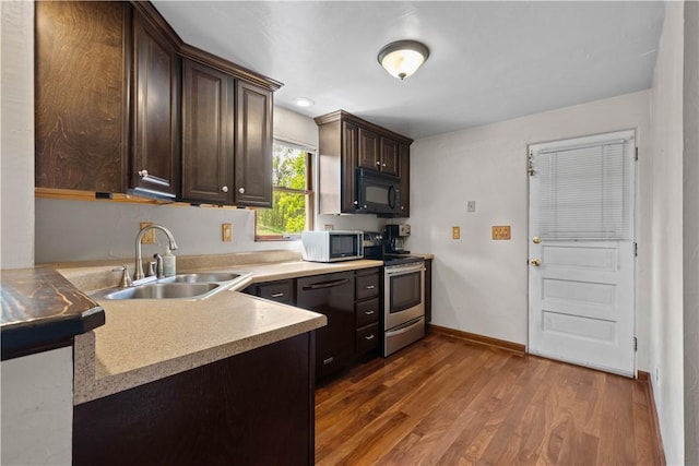 230 Brookwood Rd, Peters Twp, PA 15367 - kitchen featuring black appliances, a sink, dark brown cabinets, dark wood-style floors, and baseboards