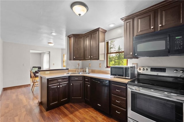 230 Brookwood Rd, Peters Twp, PA 15367 - kitchen featuring black appliances, a sink, light countertops, and dark brown cabinets