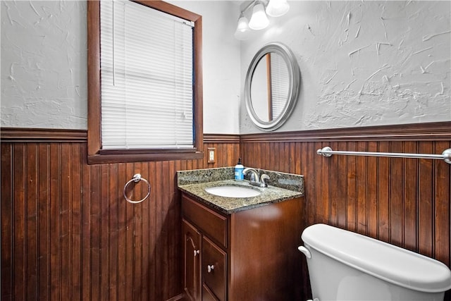 230 Brookwood Rd, Peters Twp, PA 15367 - half bath featuring wainscoting, toilet, wood walls, vanity, and a textured wall