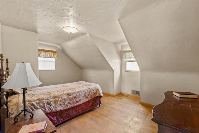 230 Brookwood Rd, Peters Twp, PA 15367 - bedroom with multiple windows, light wood-type flooring, lofted ceiling, and baseboards