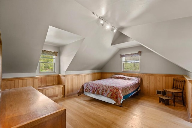230 Brookwood Rd, Peters Twp, PA 15367 - bedroom with multiple windows, light wood-style floors, rail lighting, wooden walls, and a wainscoted wall