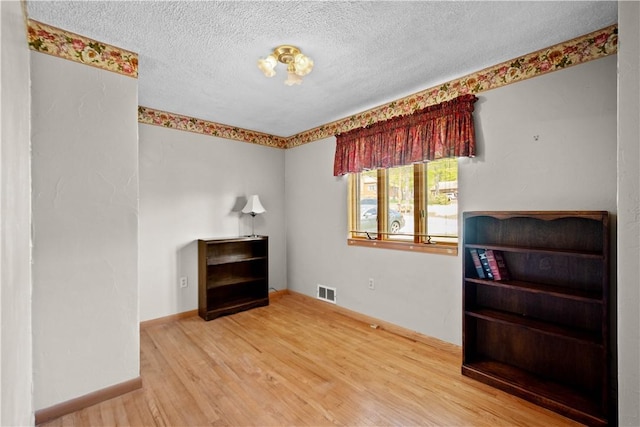 230 Brookwood Rd, Peters Twp, PA 15367 - unfurnished room with wood finished floors, a textured ceiling, and baseboards