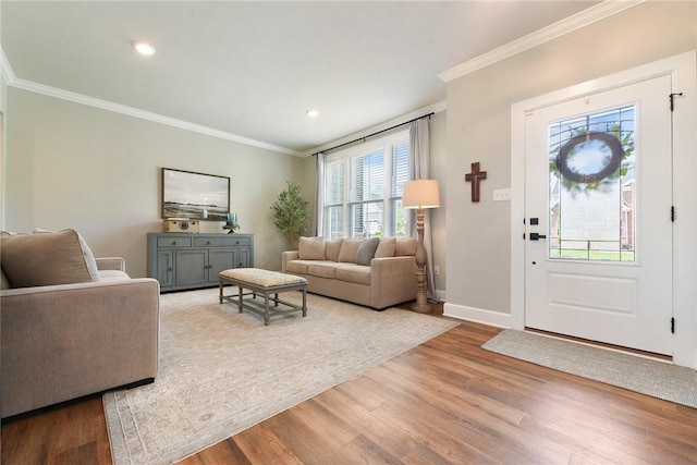 living area with crown molding, wood finished floors, baseboards, and recessed lighting