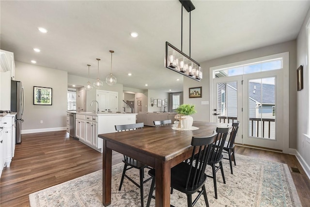 dining room featuring dark wood-type flooring, baseboards, and recessed lighting