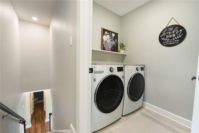 laundry room with washing machine and dryer and baseboards