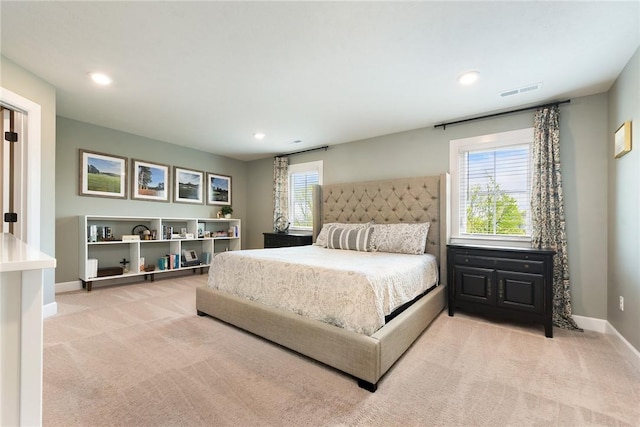 bedroom with light colored carpet, baseboards, and recessed lighting