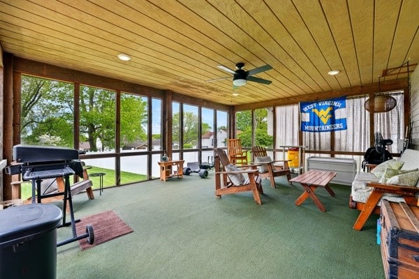 sunroom / solarium featuring wooden ceiling and carpet