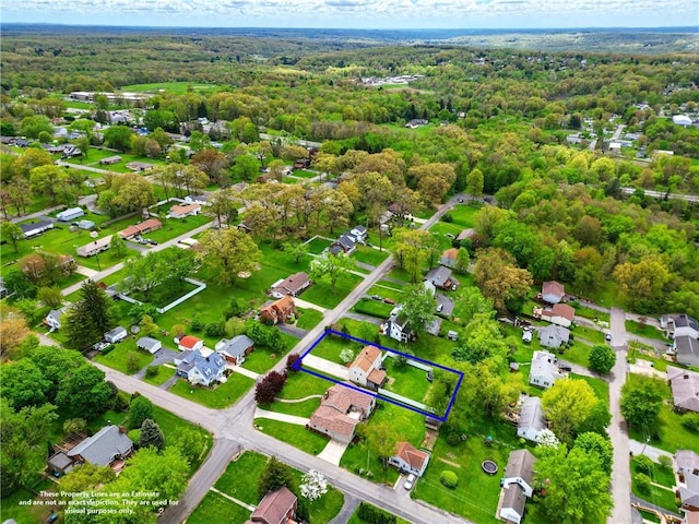 aerial view of property's location with a forest, property parcel outlined, and nearby suburban area