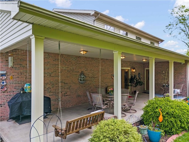 view of patio with area for grilling and outdoor dining space