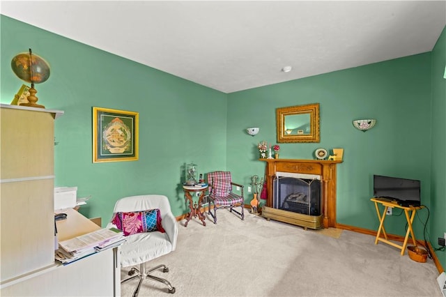 living area featuring carpet floors, a fireplace, baseboards, and an office area