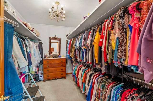 spacious closet featuring light carpet and a chandelier