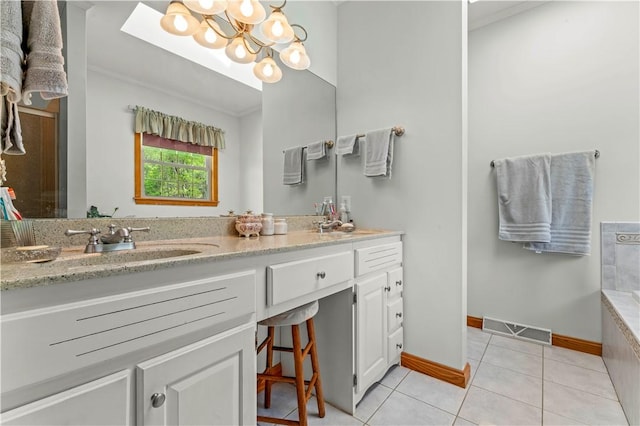 bathroom featuring tile patterned floors, vanity, a chandelier, baseboards, and tiled bath