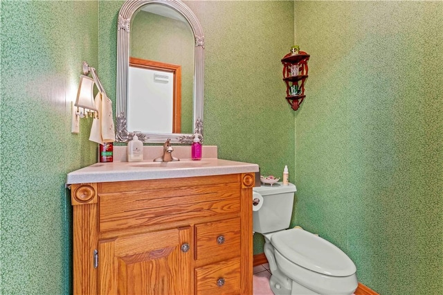 bathroom featuring toilet and vanity