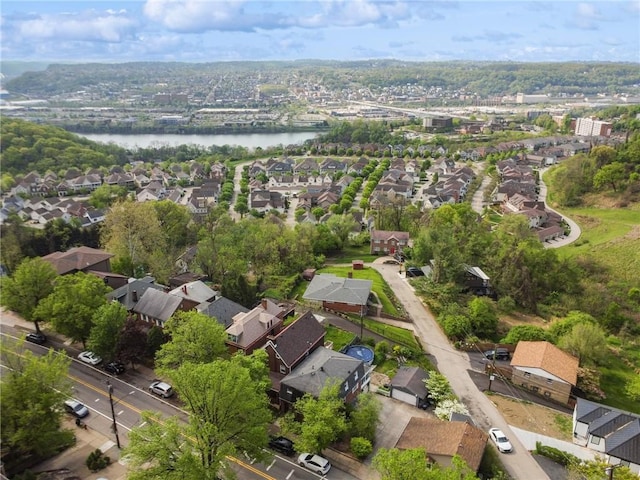 view of property location with a large body of water and nearby suburban area