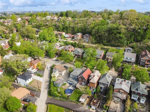 aerial view of property and surrounding area featuring nearby suburban area