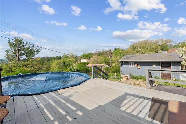 view of swimming pool featuring a wooden deck and a covered pool