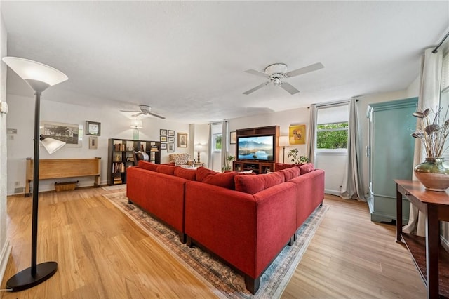 living area with ceiling fan and light wood-style floors