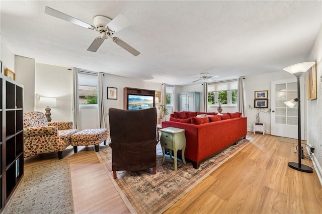 living area featuring ceiling fan and light wood finished floors