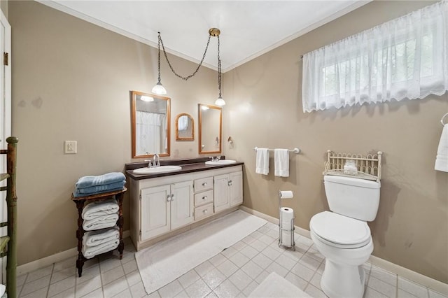 bathroom featuring toilet, ornamental molding, baseboards, double vanity, and tile patterned floors