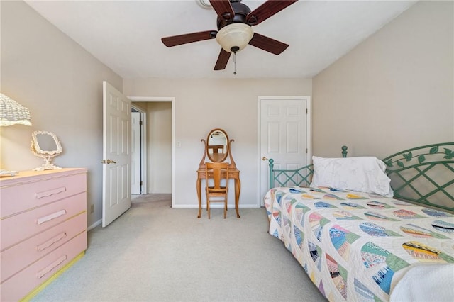 bedroom featuring light colored carpet, baseboards, and ceiling fan