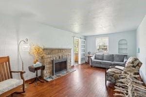 living room with wood finished floors and a fireplace
