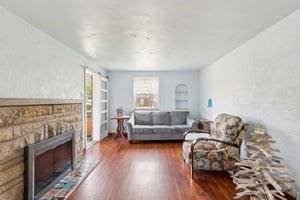 living room with wood finished floors and a fireplace