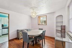 dining room featuring a chandelier and wood finished floors