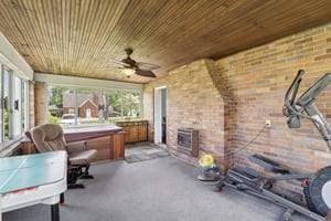 sunroom featuring a hot tub
