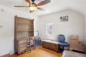 bedroom featuring wood finished floors, vaulted ceiling, and ceiling fan