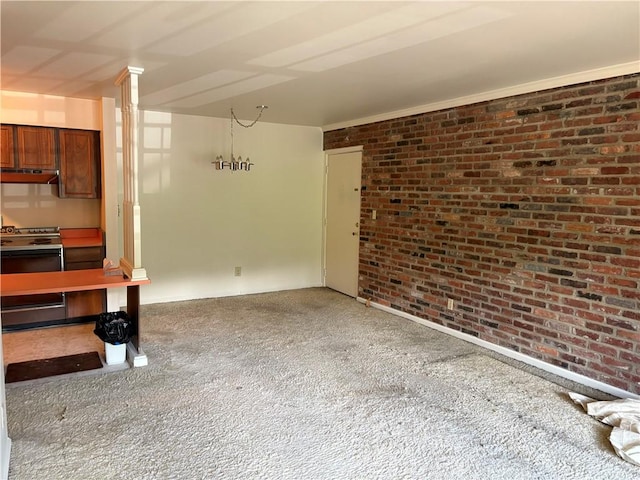 unfurnished living room featuring brick wall and carpet flooring