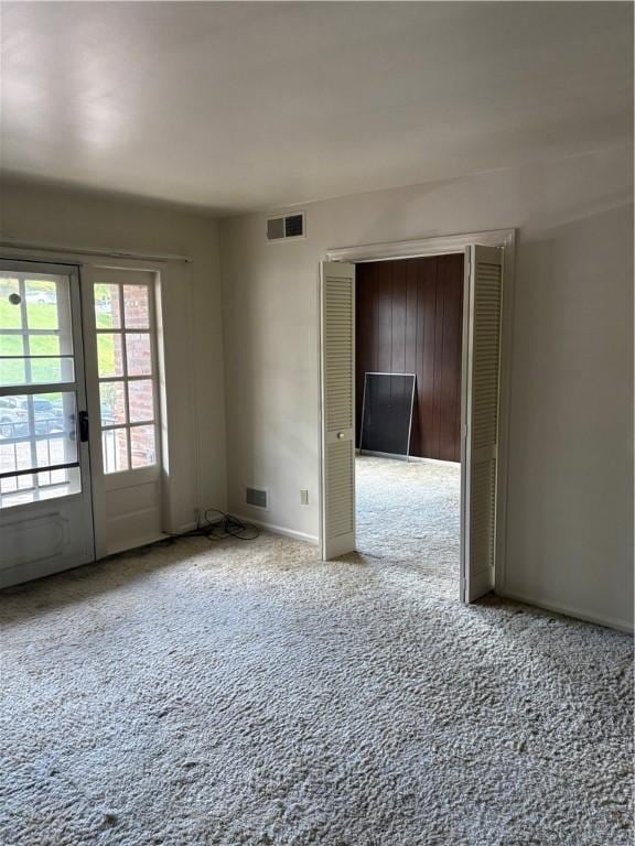 empty room with carpet and baseboards