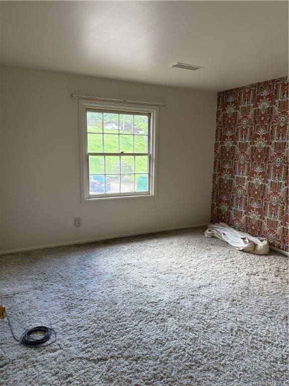 spare room with carpet flooring and baseboards