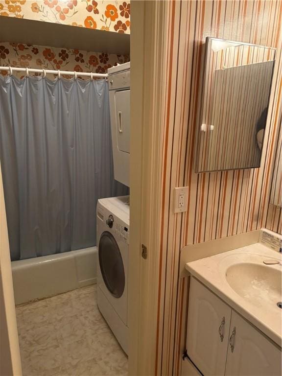 full bath with wallpapered walls, vanity, stacked washer and clothes dryer, and shower / tub combo with curtain